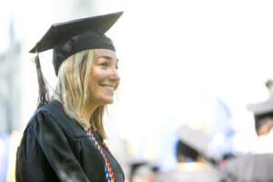 A smiling Trinity College graduate